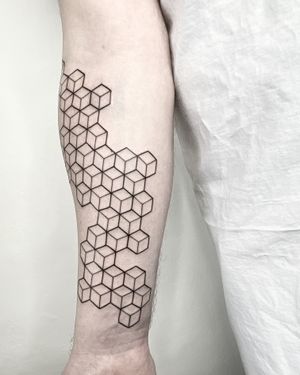 Elegantly designed tattoo by Malvina Maria Wisniewska featuring intricate fine line geometric patterns.
