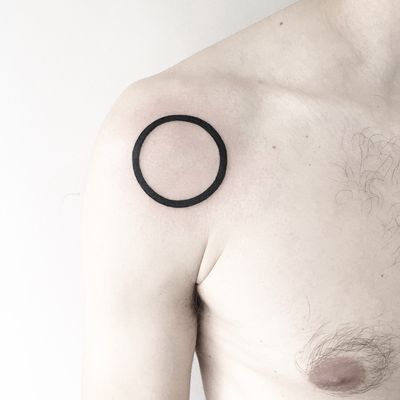 Unique blackwork tattoo featuring a bold geometric circle design by Malvina Maria Wisniewska.
