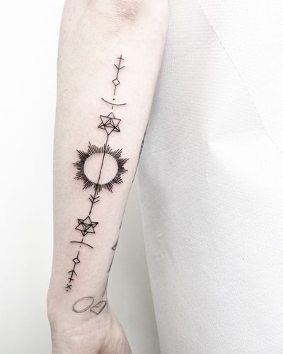 Fine line geometric tattoo of a sun symbol designed by Malvina Maria Wisniewska. Perfect for those seeking a unique and minimalist design.