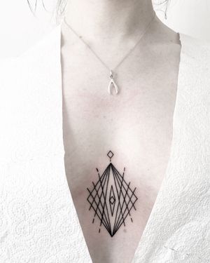 Explore the intricate design of this fine line geometric tattoo created by the talented artist Malvina Maria Wisniewska.