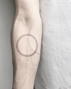 Get a beautiful fine line sun tattoo by Malvina Maria Wisniewska for a sleek and minimalist look. Perfect for adding a touch of sunshine to your body art collection.
