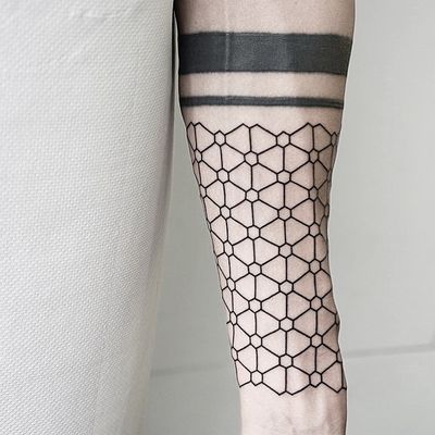 Discover the intricate beauty of this fine line, geometric pattern tattoo by Malvina Maria Wisniewska.