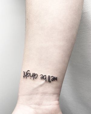 Elegant and delicate small lettering tattoo by Malvina Maria Wisniewska, perfect for a subtle and meaningful design.