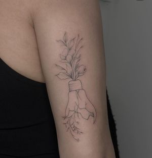 Get a unique and delicate tattoo of a flower and lightbulb in fine line, illustrative style by the talented artist Maddie.