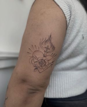 Exquisite tattoo by Maddie blending delicate fine line art with an illustrative style featuring a rose and sacred heart motif.