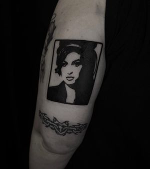 Experience the iconic beauty of Amy Winehouse in this striking blackwork portrait tattoo by the talented artist Sophia Hayes.