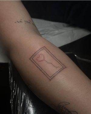 Get a stunning illustrative tattoo of a heart, stamp, and balloon by the talented artist Maddie. Perfect for a minimalist yet impactful look.