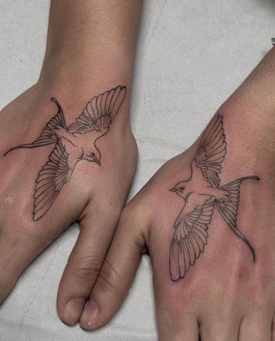 Elegant and detailed swallow tattoo done in fine line style by talented artist Maddie.