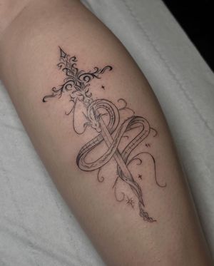 Get inked with a captivating dragon and sword design by the talented artist Maddie. Fine line and illustrative style.