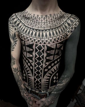 Embrace traditional tribal and ornamental designs with this mesmerizing blackwork tattoo by Francesco Capro.