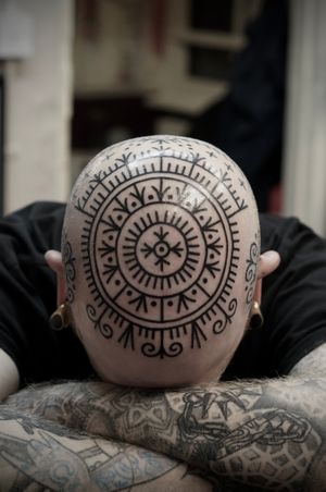 Get a stunning ornamental tattoo with detailed blackwork patterns from the talented artist Francesco Capro.