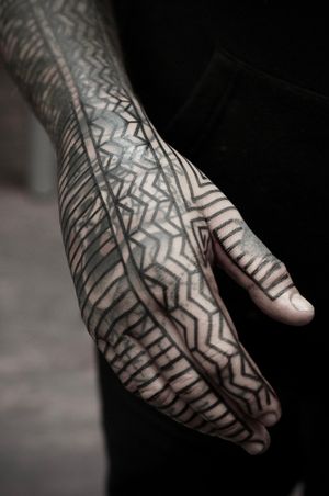 Explore the mesmerizing patterns and ornamental details in this stunning blackwork tattoo. Let Francesco Capro's skillful technique adorn your skin with a unique blastover design.