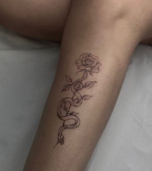 Beautifully detailed fine line snake and rose tattoo design by talented artist Maddie, combining nature and mysticism.