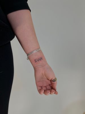 Get a stylish and subtle lettering tattoo with expert artist Faith Llewellyn for a timeless and elegant look!