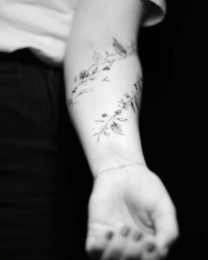 flowers and leaves tattoo on forearm#Floral