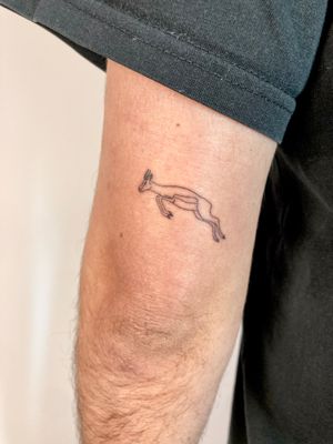 Embrace the spirit of the wild with this elegant fine line antelope tattoo by the talented artist Gee.