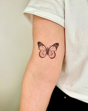 This illustrative tattoo by Ruth Hall features a delicate butterfly motif, perfect for those who appreciate the beauty of nature.