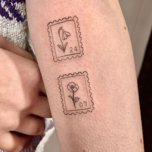 Get a beautifully detailed flower stamp tattoo done in a fine line illustrative style by Gee.