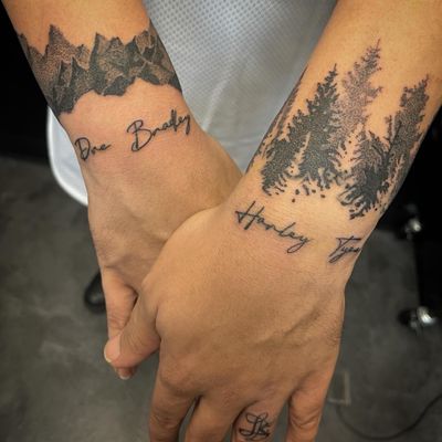 Cover up of some very faded names mountain and Forrest with new names of my clients children in my trademark handwritten font and an insignia on the ring finger for spouse 