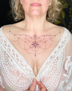 Experience the delicate beauty of Viví Bogdanov's exquisite dotwork and ornamental style tattoo.