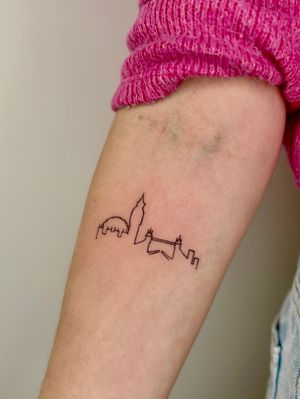 Capture the beauty of London with this intricate fine line cityscape tattoo by Ruth Hall.