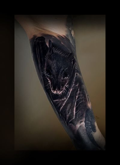 A stunning black and gray tattoo of a bat, done by the talented artist J.Tintanegra. The detailed realism brings this nocturnal creature to life.