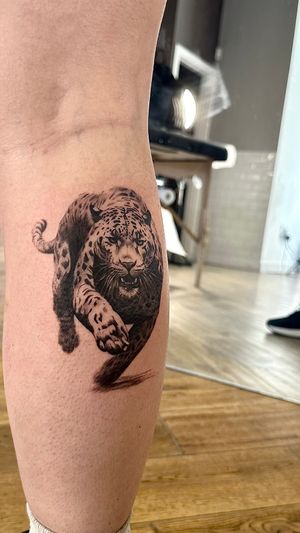 Experience the masterful black and gray artistry of Saka Tattoo with this stunning leopard and jaguar design. A true showstopper!