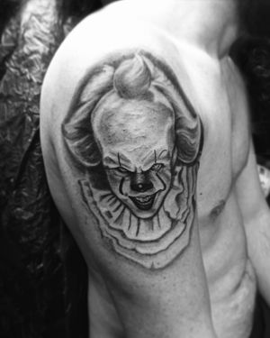 Captivating black and gray tattoo of the iconic clown from the movie It, by artist Gabriele Lacerenza.