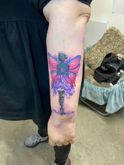 Enchant your skin with a magical fairy design by Eve inksane, featuring vibrant watercolor details.