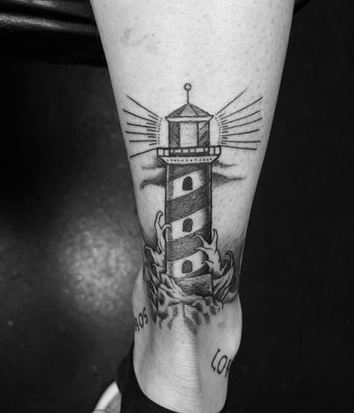 Get lost in the beauty of the sea with this illustrative tattoo featuring a majestic lighthouse, done by the talented artist Gabriele Lacerenza.
