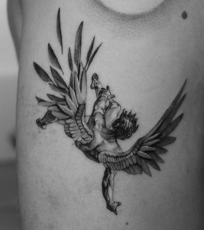 A captivating black and gray illustrative tattoo depicting the tragic fall of Icarus, created by Gabriele Lacerenza.
