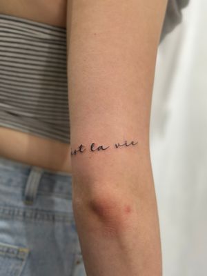 Express yourself with subtle charm with this small lettering tattoo by Saka Tattoo, perfect for a delicate touch of personal flair.