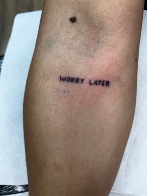 Get a personalized small lettering tattoo by Jonathan Glick, creating a sophisticated and timeless design.
