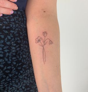 Elegant and intricate dotwork and fine line tattoo featuring a delicate flower design, expertly executed by the talented artist Chloe Hartland.