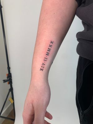 Express yourself with a small and delicate lettering tattoo by Chloe Hartland. Perfect for a subtle yet meaningful touch.