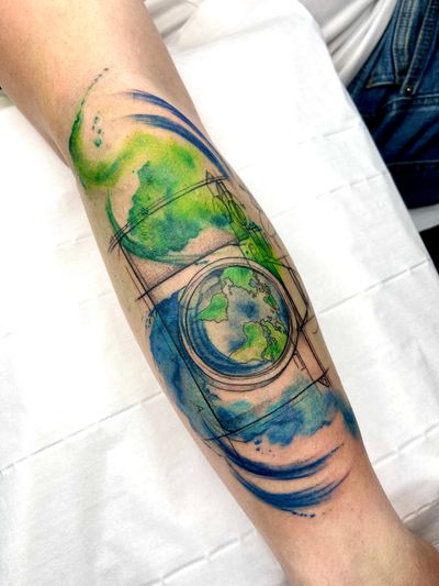 Embrace the beauty of our planet with this stunning geometric watercolor tattoo by Beyza Taser. A unique blend of earthy tones and intricate design.
