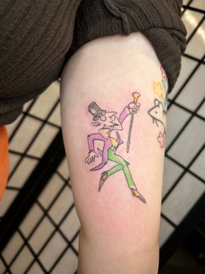 Get a whimsical twist on the classic Willy Wonka character with this edgy and bold illustrative tattoo by Jonathan Glick.