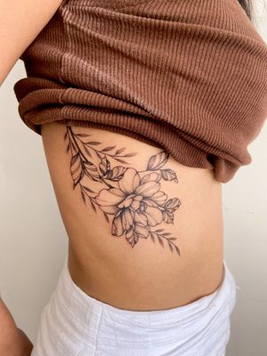 Beautiful and intricate flower tattoo by Gabriela, combining delicate linework with detailed shading for a stunning design.