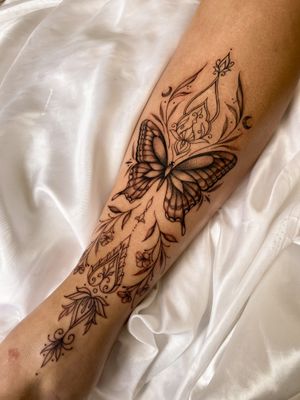 Embrace the beauty of nature with this elegant fine line butterfly tattoo by artist Gabriela. Perfect for those looking for a delicate and detailed design.