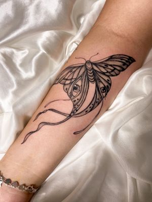 Beautiful black and gray tattoo design combining a butterfly, moth, and eye, by artist Gabriela.