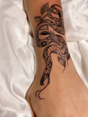 Experience the captivating blend of nature and mystique with this illustrative snake and plant tattoo by Gabriela.