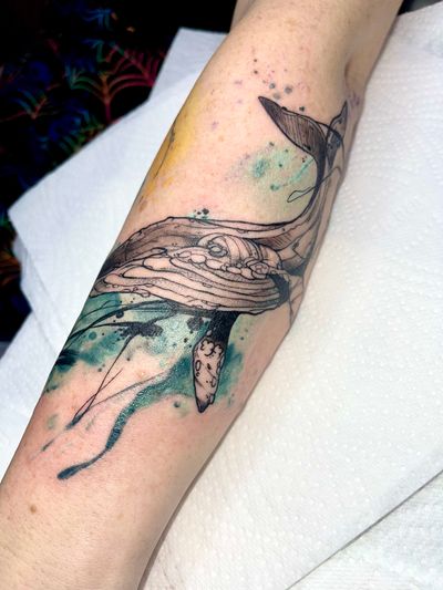Get mesmerized by this enchanting whale tattoo designed by Beyza Taser, blending illustrative sketch with dreamy watercolor effects.