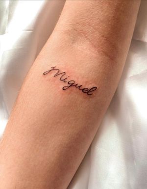 Get a beautifully intricate small lettering tattoo of your name done by the talented artist Gabriela. Perfect for a subtle yet personal touch.