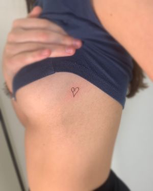 Get a fine line heart tattoo that is both elegant and timeless, expertly done by Chloe Hartland.
