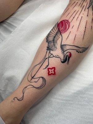 Beautiful illustrative tattoo by Beyza Taser featuring red ink, marble, crane, and heron motifs.