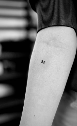 Get a beautifully intricate small lettering tattoo by the talented artist Tal. Express yourself in style with this unique piece of body art.