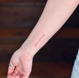 Get a beautifully crafted small lettering tattoo with intricate fine lines by the talented artist Tal.