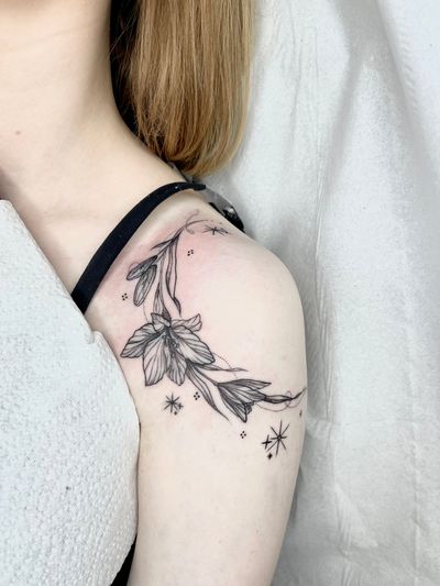 Embrace the beauty of nature with this delicate flower motif tattoo, expertly crafted by Beyza Taser in fine line style. Perfect for those seeking a touch of elegance.