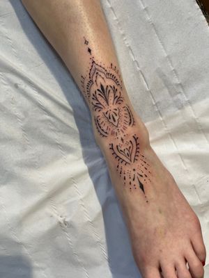 Experience the intricate beauty of this dainty and delicate fine line ornamental tattoo expertly crafted by Beyza Taser.