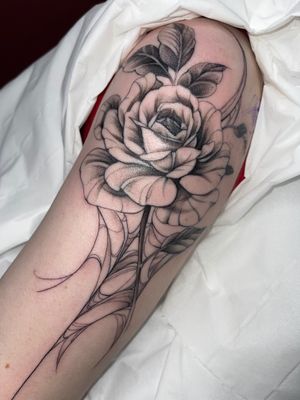 Elegant and detailed dotwork rose tattoo designed by Beyza Taser, combining floral and fine line elements for a unique look.